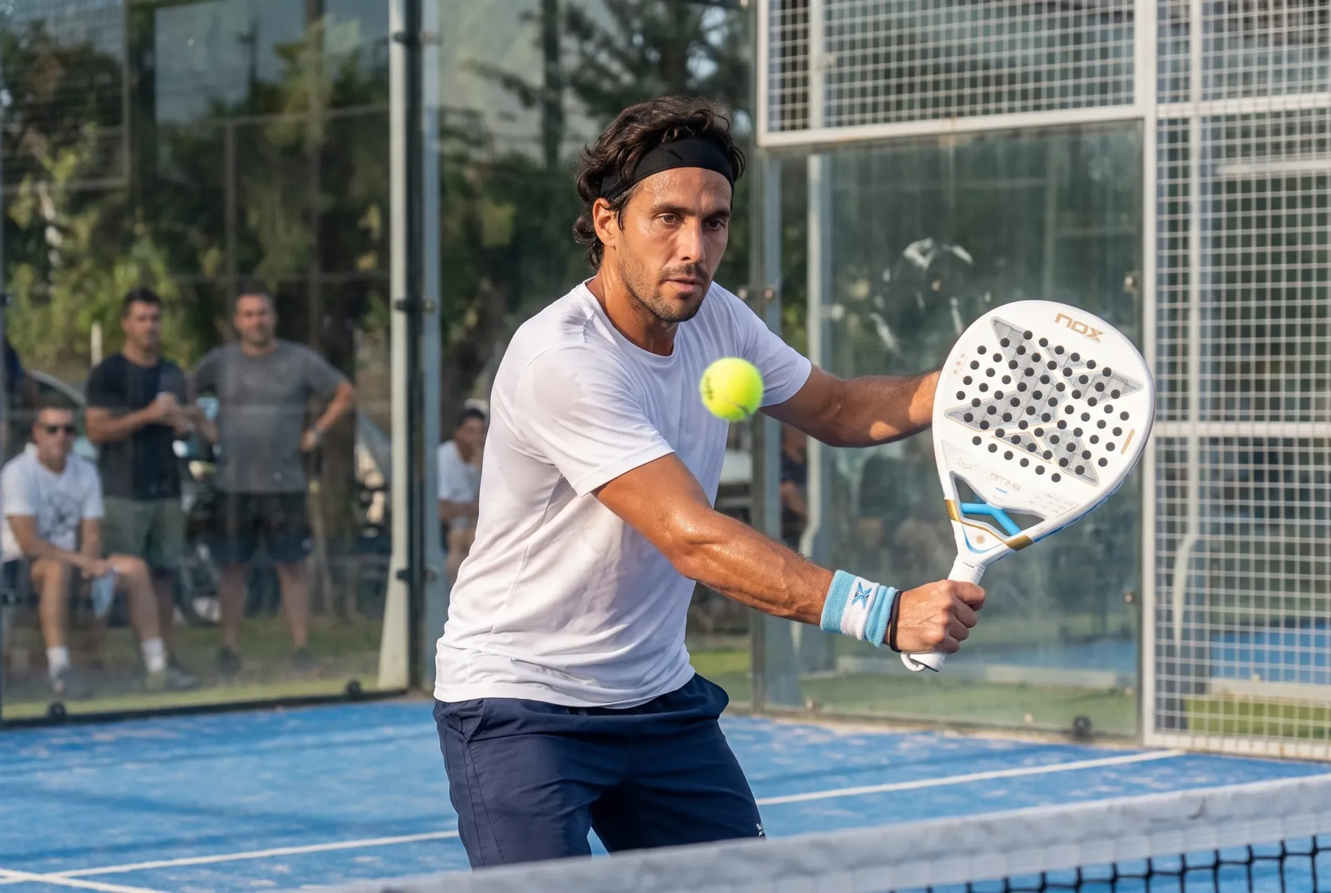 Player hitting a backhand volley at the net with the Nox AT10 Genius 18K Alum Argentina